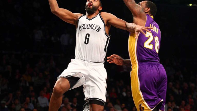 Brooklyn Nets point guard Deron Williams #8 drives against Los Angeles Lakers power forward Tarik Black #28 during the second quarter of a game at Barclays Center on Sunday, March 29, 2015.