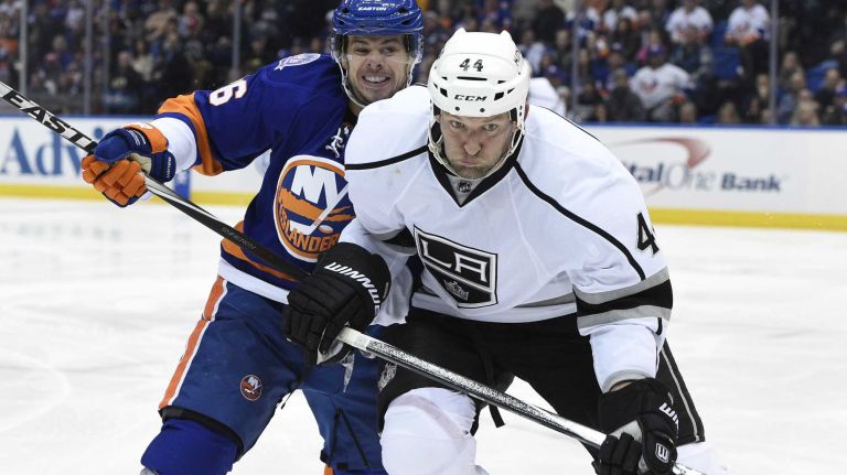 Los Angeles Kings defenseman Robyn Regehr battles with New York Islanders center Tyler Kennedy in the third period of an NHL hockey game at Nassau Coliseum on Thursday, March 26, 2015. The Kings defeated the Islanders 3-2.
