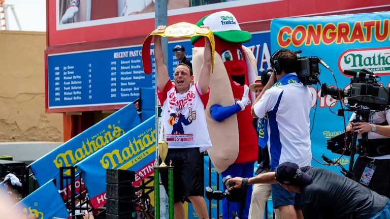 Joey Chestnut won  the men's division -- again -- of the 2018 Nathan's Hot Dog Eating Contest with a record-breaking 74 dogs on Wednesday, July 4, 2018.. 