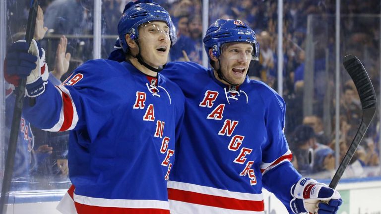 Jesper Fast #19 of the New York Rangers celebrates his third-period goal against the Anaheim Ducks with teammate Matt Hunwick #44 at Madison Square Garden on Sunday, March 22, 2015.