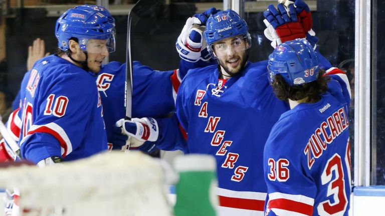 Derick Brassard #16 of the New York Rangers celebrates his third-period goal against the Anaheim Ducks with teammates Mats Zuccarello #36 and J.T. Miller #10 at Madison Square Garden on Sunday, March, 22, 2015.