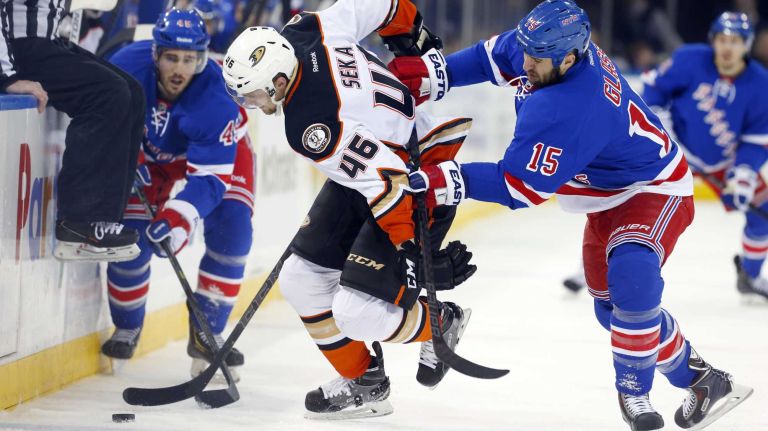 Tanner Glass #15 of the New York Rangers defends against Jiri Sekac #46 of the Anaheim Ducks at Madison Square Garden on Sunday, March 22, 2015.