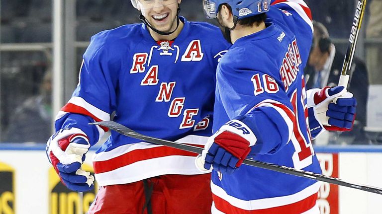 Derek Stepan #21 of the New York Rangers celebrates his first-period power-play goal against the Anaheim Ducks with teammate Derick Brassard #16 at Madison Square Garden on Sunday, March 22, 2015.