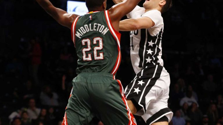 Bojan Bogdanovic of the Brooklyn Nets goes to the hoop against Khris Middleton of the Milwaukee Bucks during the first half at Barclays Center on Friday, March 20, 2015.
