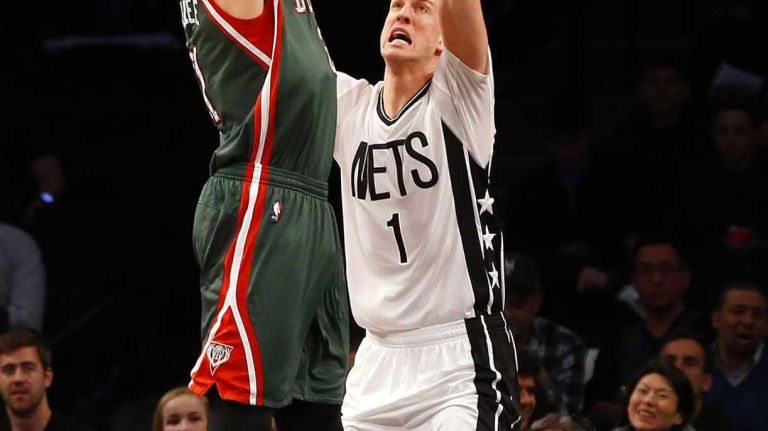 Miles Plumlee of the Milwaukee Bucks shoots over Mason Plumlee of the Brooklyn Nets in the first half at Barclays Center on Friday, March 20, 2015.
