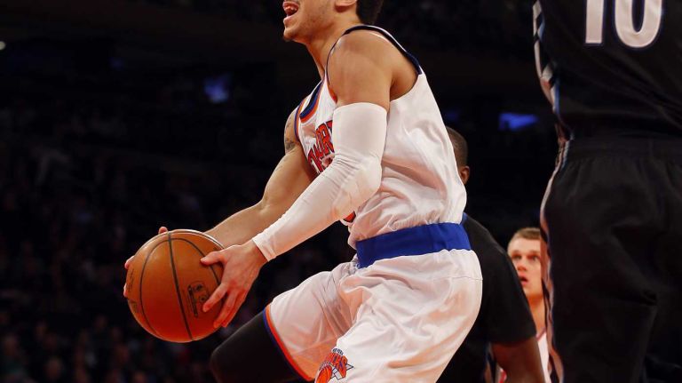Shane Larkin #0 of the New York Knicks goes to the hoop in the first half against Chase Budinger #10 of the Minnesota Timberwolves during a game at Madison Square Garden on Thursday, March 19, 2015.