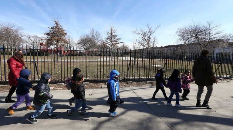 Children walk along the fence at Maria Hernandez Park on Knickerbocker Ave. in Bushwick.