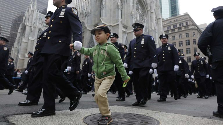 New York City Police Department officers march in the 245th annual St. Patrick's Day parade along Fifth Avenue on Tuesday, March 17, 2015.