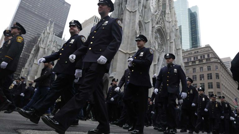 New York City Police Department officers march in the 245th annual St. Patrick's Day parade along Fifth Avenue on Tuesday, March 17, 2015.