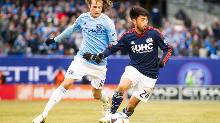 New England Revolution midfielder/forward Lee Nguyen (24) is pursued by New York City FC midfielder Mix Diskerud (10) during a game at Yankee Stadium on Sunday, March 15, 2015.
