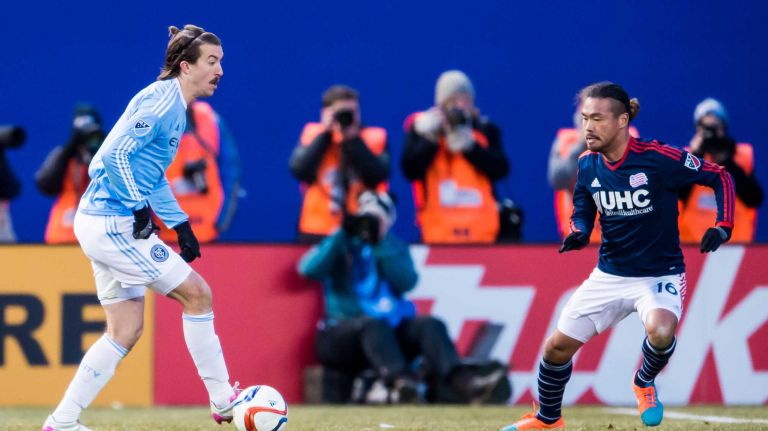 New York City FC defender Jeb Brovsky (5) is defended by New England Revolution midfielder Daigo Kobayashi (16) during a game at Yankee Stadium on Sunday, March 15, 2015.