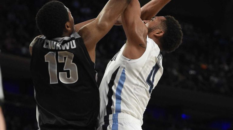 Villanova Wildcats guard Darrun Hilliard II is fouled by Providence Friars center Paschal Chukwu in a Big East semifinal men's basketball game at Madison Square Garden on Friday, March 13, 2015.