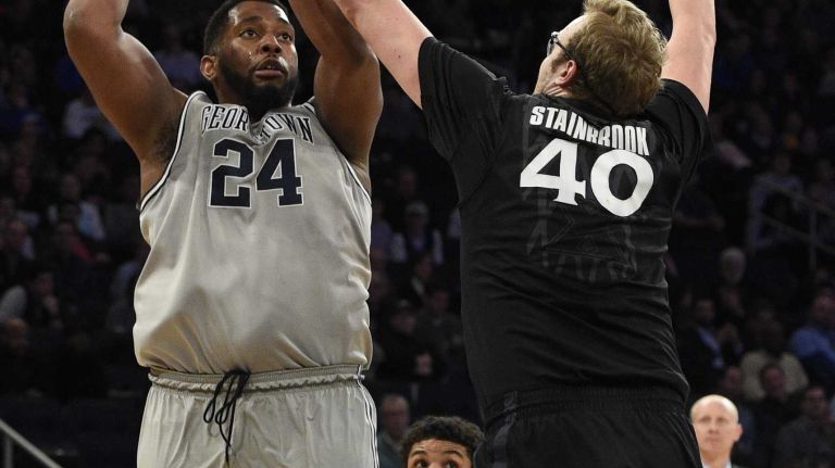 Big East Tournament semifinal: Georgetown vs. Xavier 32 Georgetown Hoyas center Joshua Smith sinks a shot past Xavier Musketeers center Matt Stainbrook in a Big East semifinal men's basketball game at Madison Square Garden on Friday, March 13, 2015.