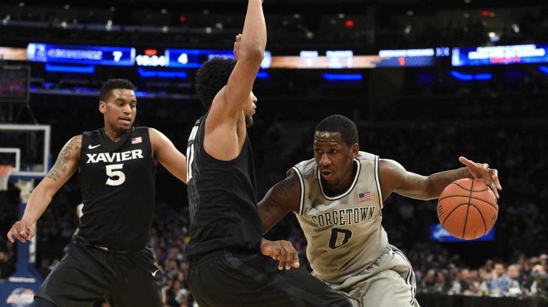 Big East Tournament semifinal: Georgetown vs. Xavier 35 Georgetown Hoyas center L.J. Peak drives against Xavier Musketeers guard Dee Davis in a Big East semifinal men's basketball game at Madison Square Garden on Friday, March 13, 2015.