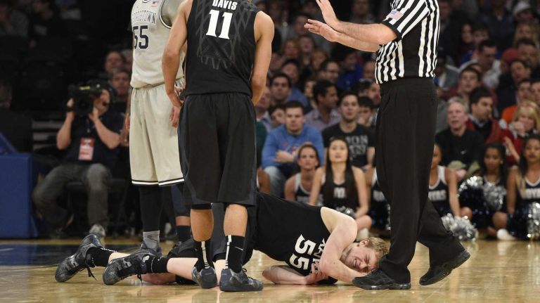 Big East Tournament semifinal: Georgetown vs. Xavier 41 Xavier Musketeers guard J.P. Macura reacts not he court to an injury against the Georgetown Hoyas in a Big East semifinal men's basketball game at Madison Square Garden on Friday, March 13, 2015.
