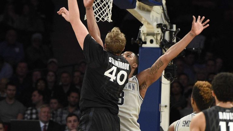 Big East Tournament semifinal: Georgetown vs. Xavier 42 Xavier Musketeers center Matt Stainbrook sinks a layup against Georgetown Hoyas forward Mikael Hopkins in a Big East semifinal men's basketball game at Madison Square Garden on Friday, March 13, 2015.