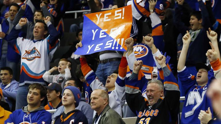 New York Islanders fans celebrate a third period goal against the Ottawa Senators at Nassau Coliseum on Friday, March 13, 2015.