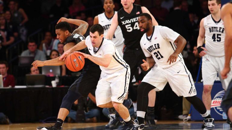 Butler Bulldogs guard Alex Barlow leads a fast break past Xavier Musketeers forward Trevon Bluiett during the first half of a Big East Tournament game at Madison Square Garden on Thursday, March 12, 2015.