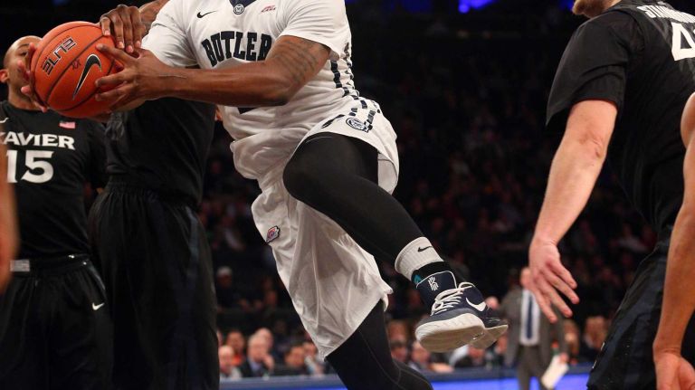 Butler Bulldogs forward Roosevelt Jones drives past Xavier Musketeers forward Jalen Reynolds and Xavier Musketeers center Matt Stainbrook during the first half of a Big East Tournament game at Madison Square Garden on Thursday, March 12, 2015.