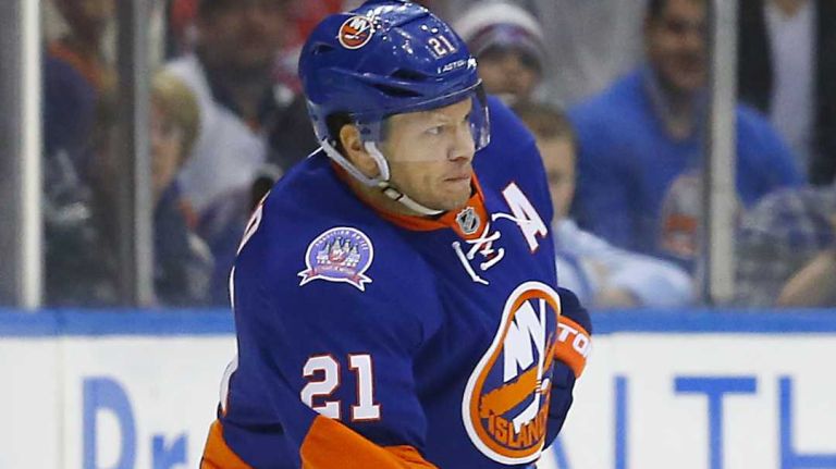 Kyle Okposo of the New York Islanders plays the puck against Derek Stepan of the New York Rangers at Nassau Coliseum on Tuesday, March 10, 2015.