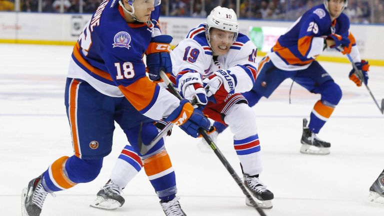 Ryan Strome of the New York Islanders attempts a shot as Jesper Fast of the New York Rangers defends at Nassau Coliseum on Tuesday, March 10, 2015.