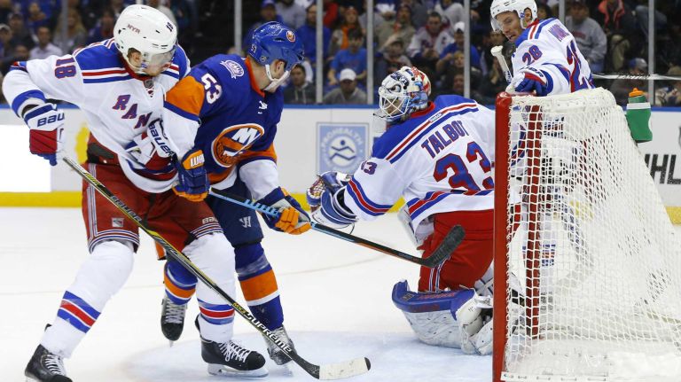 Cam Talbot of the New York Rangers makes a third-period save against Casey Cizikas of the New York Islanders at Nassau Coliseum on Tuesday, March 10, 2015.