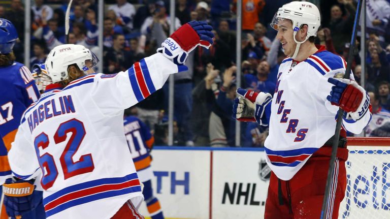 Kevin Hayes of the New York Rangers celebrates his second-period goal against the New York Islanders with teammate Carl Hagelin at Nassau Coliseum on Tuesday, March 10, 2015.