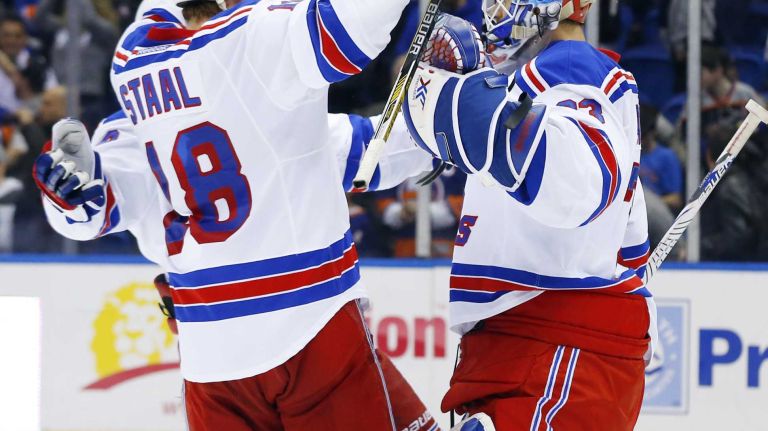 Cam Talbot and Marc Staal of the New York Rangers celebrate after defeating the New York Islanders at Nassau Coliseum on Tuesday, March 10, 2015.