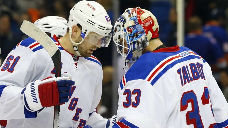 Rick Nash and Cam Talbot of the New York Rangers celebrate after defeating the New York Islanders at Nassau Coliseum on Tuesday, March 10, 2015.