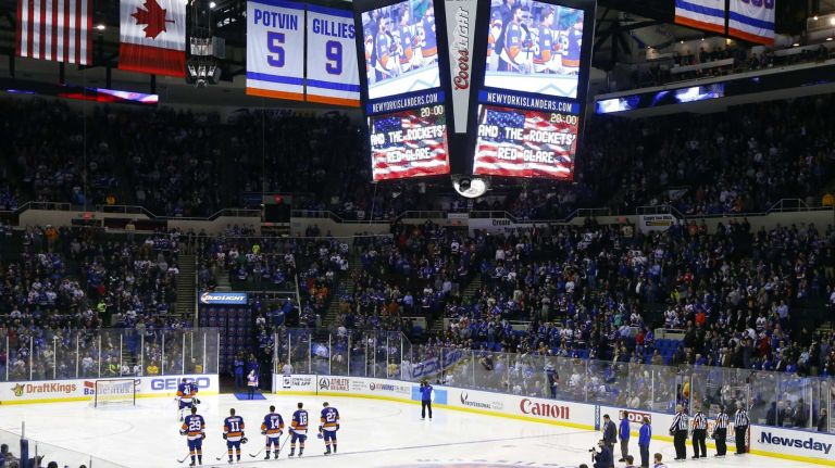 The New York Islanders and the New York Rangers stand during the national anthem before their game at Nassau Coliseum on Tuesday, March 10, 2015.