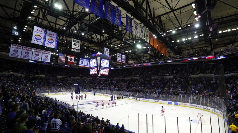 The New York Islanders and the New York Rangers stand during the national anthem before their game at Nassau Coliseum on Tuesday, March 10, 2015.