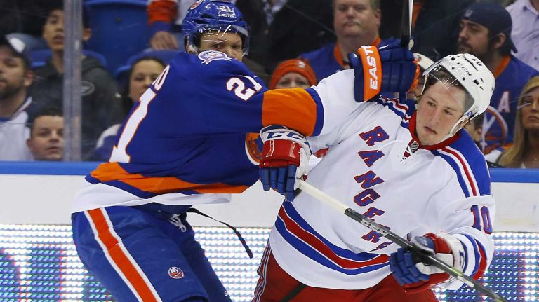 Kyle Okposo of the New York Islanders checks J.T. Miller of the New York Rangers in the first period at Nassau Coliseum on Tuesday, March 10, 2015.