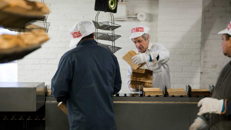Cooled matzo, fresh from the oven, is readied for packaging as it makes its way along the production line at the Streit's Matzo Factory in Manhattan Monday, March 9, 2015. The factory, a long-established part of the Lower East Side since 1925, is planning to leave the spot by this summer.