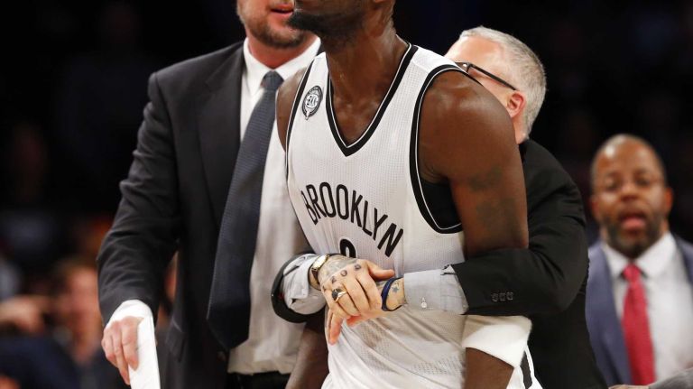 Kevin Garnett #2 of the Brooklyn Nets is restrained by team personnel after an altercation with Dwight Howard #12 of the Houston Rockets at Barclays Center on Monday, Jan. 12, 2015.