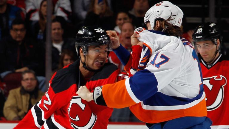 Mark Fraser of the New Jersey Devils fights with Matt Martin of the New York Islanders during the second period at the Prudential Center on Jan. 9, 2015 in Newark, N.J.