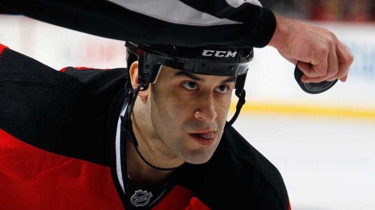 Scott Gomez of the New Jersey Devils waits for the puck to drop during a second period face-off against the New York Islanders at the Prudential Center on Jan. 9, 2015 in Newark, N.J.