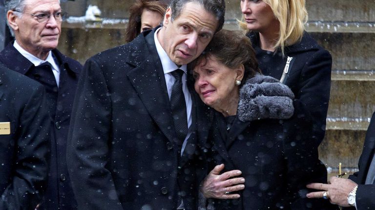 Gov. Andrew Cuomo hugs his mother Matilda Cuomo as they watch a casket carrying Gov. Mario Cuomo pass by at the end of the funeral for the elder Cuomo Jan. 6, 2105, at St. Ignatius Church in Manhattan.