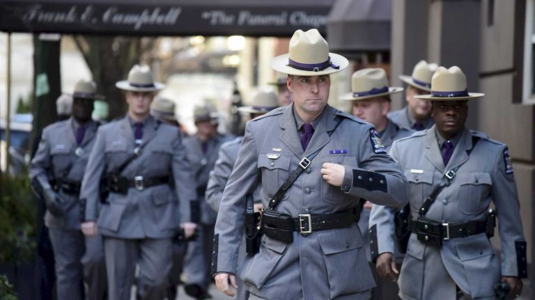 New York State troopers arrive at Frank E. Campbell Funeral Chapel in Manhattan before the wake for former Gov. Mario Cuomo on Monday, Jan. 5, 2015. 