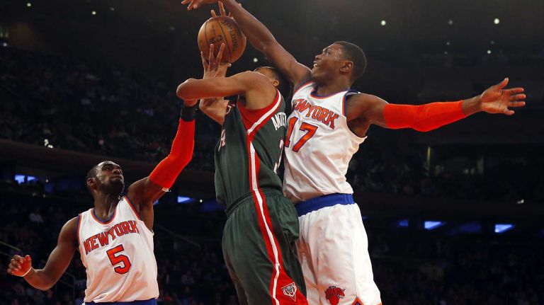 Giannis Antetokounmpo #34 of the Milwaukee Bucks draws a foul against Tim Hardaway Jr. #5 of the New York Knicks as Cleanthony Early #17 defends at Madison Square Garden on Sunday, Jan. 4, 2015 in New York City.