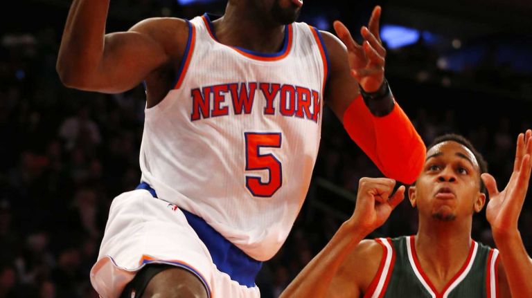 Tim Hardaway Jr. #5 of the New York Knicks drives to the hoop against John Henson #31 of the Milwaukee Bucks at Madison Square Garden on Sunday, Jan. 4, 2015 in New York City.