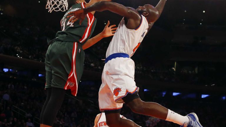 Quincy Acy #4 of the New York Knicks dunks the ball against Giannis Antetokounmpo #34 of the Milwaukee Bucks at Madison Square Garden on Sunday, Jan. 4, 2015 in New York City.
