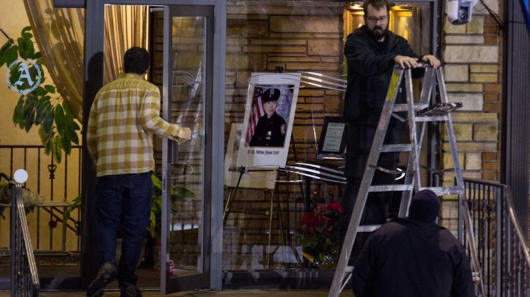 Preparations are made early Jan. 4, 2015, in Dyker Heights, Brooklyn, for the funeral of NYPD Det. Wenjian Liu, one of two officers slain Dec. 20. 