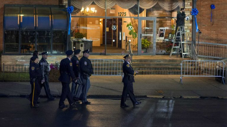 Police officers and others arrive in Dyker Heights, Brooklyn, for the funeral on Jan. 4, 2015, of NYPD Det. Wenjian Liu, one of two officers slain execution-style on Dec. 20. 