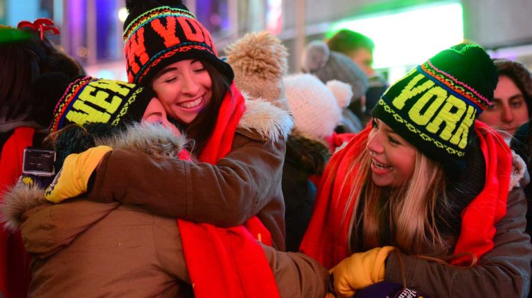 Revelers Lindsay Wells, left, Brianna Windover and Stacy Wells of Los Angeles celebrate New Year's Eve in Time Square on Dec. 31, 2014.