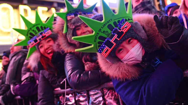 Hitomi Date, Saki Kokubo and Miku Tsubata, all of Tokyo, celebrate New Year's Eve in Times Square in Manhattan on Dec. 31, 2014.