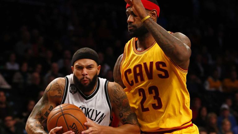 Deron Williams #8 of the Brooklyn Nets drives against LeBron James #23 of the Cleveland Cavaliers in the first quarter at Barclays Center on Monday, Dec. 8, 2014.
