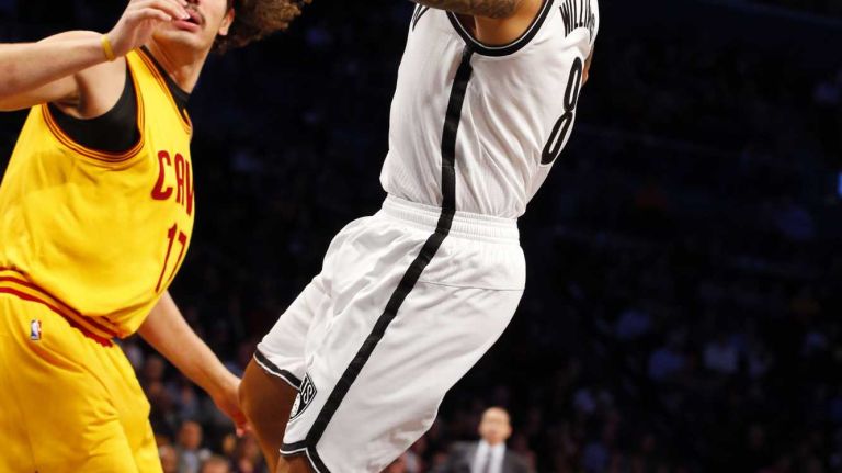 Deron Williams #8 of the Brooklyn Nets lays up a basket in the first quarter against the Cleveland Cavaliers at Barclays Center on Monday, Dec. 8, 2014.