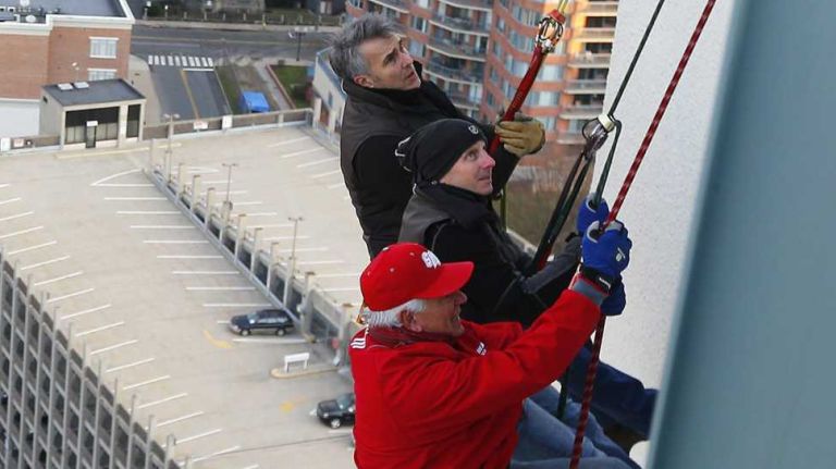 Brian Cashman rappels down building 21 Yankees GM Brian Cashman and Bobby Valentine prepare to repel 22 stories of the Landmark building at Landmark Square on Dec 5. 2014 in East Stamford, Connecticut.