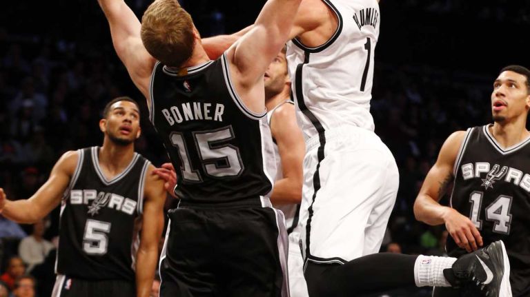Mason Plumlee of the Brooklyn Nets puts up a shot against Matt Bonner of the San Antonio Spurs during an NBA game at Barclays Center on Wednesday, Dec. 3, 2014.