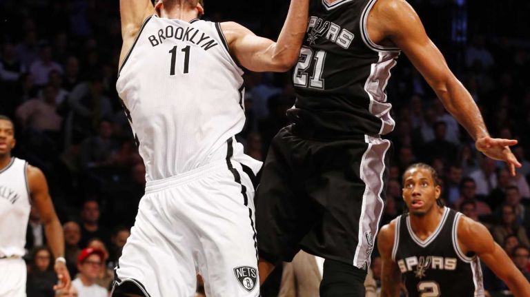 Tim Duncan of the San Antonio Spurs blocks a shot attempt from Brook Lopez of the Brooklyn Nets during an NBA game at Barclays Center on Wednesday, Dec. 3, 2014.